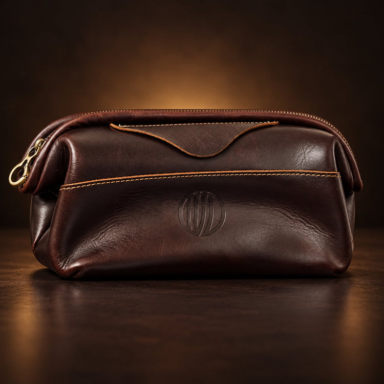 Vintage Coffee Leather Pouch from the front in dark coffee-brown leather with tan stitching and a small engraved round logo