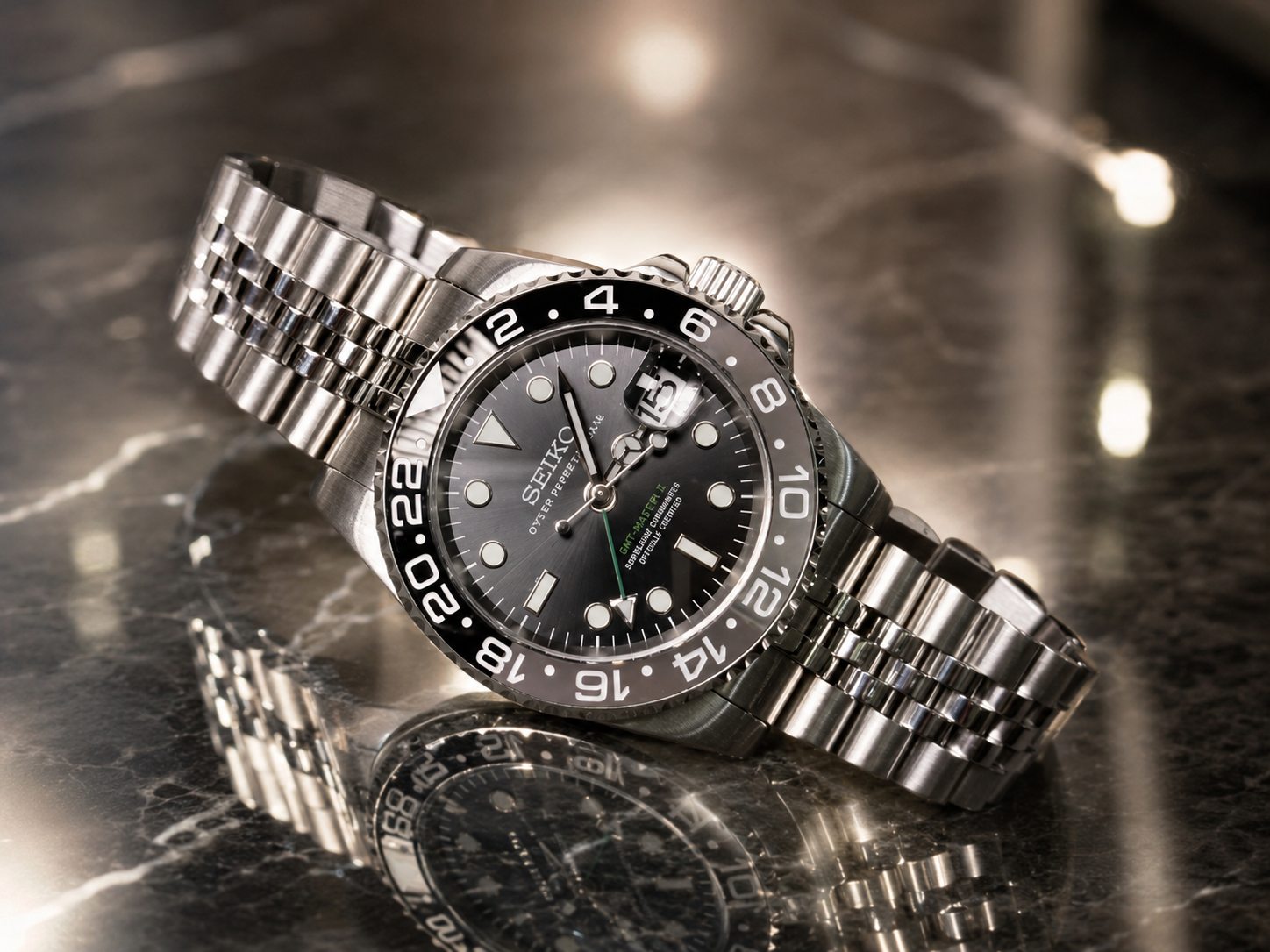 Seiko GMT Bruce Wayne custom mod watch with Jubilee bracelet on dark marble