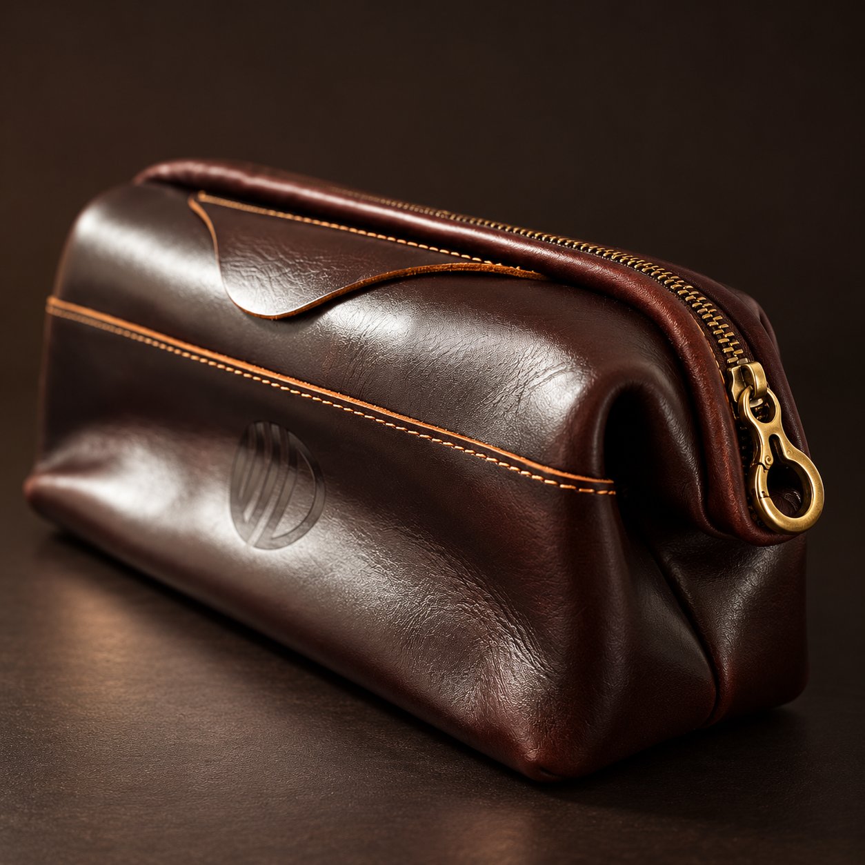 Vintage Coffee Leather Pouch in a low three-quarter view with the brass hook-style zip pull and engraved logo